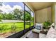 Relaxing screened patio with cozy seating area overlooking the lush backyard at 2119 Broadway View Ave, Brandon, FL 33510