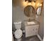 Updated half bathroom featuring modern vanity and stylish round mirror at 2209 Belleair Rd # C3, Clearwater, FL 33764