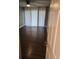 Bedroom with dark hardwood floors, neutral walls, and sliding glass door at 2209 Belleair Rd # C3, Clearwater, FL 33764