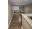 Spacious living room area with wood-look flooring and a modern ceiling fan at 2209 Belleair Rd # C3, Clearwater, FL 33764