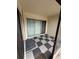 Cozy patio featuring black and gray checkered flooring, sliding glass doors, and a neutral color scheme at 2209 Belleair Rd # C3, Clearwater, FL 33764