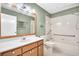 Bathroom with vanity, a large mirror, decorative lighting and a shower-tub combo with accessibility features at 2222 Norwegian Dr # 16, Clearwater, FL 33763
