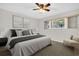 Relaxing bedroom features a large bed with a plush rug, bedside tables, and natural light from the window at 2222 Norwegian Dr # 16, Clearwater, FL 33763