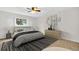 Bright bedroom featuring a stylish bed, modern decor, and a view through a large window at 2222 Norwegian Dr # 16, Clearwater, FL 33763