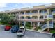A three story exterior of the property with balconies, parking, and landscaping at 2222 Norwegian Dr # 16, Clearwater, FL 33763