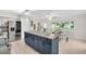 Bright eat-in kitchen featuring center island, stainless appliances, and sunlit dining nook at 2222 Norwegian Dr # 16, Clearwater, FL 33763