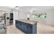 Bright kitchen features a large island with dark cabinets, stainless steel refrigerator, and large bay window at 2222 Norwegian Dr # 16, Clearwater, FL 33763
