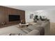 Open concept living room with modern furniture, wood accent wall, and dining area at 2222 Norwegian Dr # 16, Clearwater, FL 33763