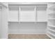 Spacious walk-in closet with custom shelving and hanging rods, ready for organized storage at 2222 Norwegian Dr # 16, Clearwater, FL 33763