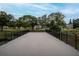 Walkway and deck overlook lush greenery, and landscaping near condominium complex at 2222 Norwegian Dr # 16, Clearwater, FL 33763