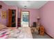 Cozy bedroom with a charming quilt, recliner, and open access to an outdoor screened-in pool at 2319 Canfield Dr, Spring Hill, FL 34609
