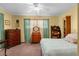 Cozy bedroom with neutral wall-to-wall carpet, a ceiling fan, and a closet at 2319 Canfield Dr, Spring Hill, FL 34609