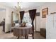 Charming breakfast nook with a round table, white wicker furniture, and access to the pool area at 2319 Canfield Dr, Spring Hill, FL 34609
