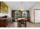 Traditional dining room with tile floors, decorative windows, and a vintage-style chandelier at 2319 Canfield Dr, Spring Hill, FL 34609