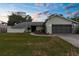 Charming single-story home featuring a well-maintained lawn and a two-car garage at 2319 Canfield Dr, Spring Hill, FL 34609