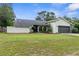 Charming single-story home featuring a well-maintained lawn and a two-car garage at 2319 Canfield Dr, Spring Hill, FL 34609