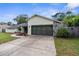 Charming single-story home featuring a well-maintained lawn and a two-car garage at 2319 Canfield Dr, Spring Hill, FL 34609