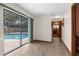 Bright hallway leading to the pool area with tile flooring and views of the backyard at 2319 Canfield Dr, Spring Hill, FL 34609
