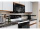 Close-up of kitchen appliances including oven, microwave, and toaster at 2319 Canfield Dr, Spring Hill, FL 34609