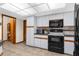 Bright kitchen with black oven and microwave, and tiled flooring at 2319 Canfield Dr, Spring Hill, FL 34609