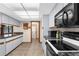 Well-lit kitchen with sleek countertops, white cabinets, and modern appliances at 2319 Canfield Dr, Spring Hill, FL 34609