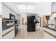 Open kitchen with granite counters and stainless steel appliances and adjoining living area at 2319 Canfield Dr, Spring Hill, FL 34609