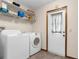 Functional laundry room with washer, dryer, and shelving for storage at 2319 Canfield Dr, Spring Hill, FL 34609
