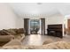 Bright living room featuring tile flooring, a comfortable sofa, and sliding glass doors to the pool area at 2319 Canfield Dr, Spring Hill, FL 34609