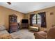 Comfortable living room featuring tile floors, wood furniture, brown walls, and a view of the outdoors at 2319 Canfield Dr, Spring Hill, FL 34609