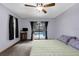 Well-lit main bedroom showing ceiling fan, and sliding glass doors with view of pool at 2319 Canfield Dr, Spring Hill, FL 34609