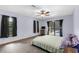 Comfortable bedroom with a ceiling fan and sliding doors to the pool at 2319 Canfield Dr, Spring Hill, FL 34609