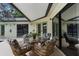 Outdoor patio setup with wicker chairs, glass table, and direct view and access to the pool at 2319 Canfield Dr, Spring Hill, FL 34609