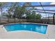 Inviting screened-in pool area, perfect for relaxing and enjoying the outdoors at 2319 Canfield Dr, Spring Hill, FL 34609