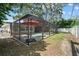 A screened-in pool is located in the backyard of this house, with lush greenery surrounding at 2353 Eastwood Dr, Clearwater, FL 33765