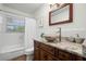 Charming bathroom with a decorative bowl sink, granite countertop, and tiled walls at 2353 Eastwood Dr, Clearwater, FL 33765