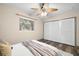 Bright bedroom with wood-look flooring, a ceiling fan, and a closet providing ample storage space at 2353 Eastwood Dr, Clearwater, FL 33765