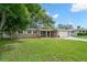 Charming single-story home with a well-manicured lawn, mature trees, and an attached two-car garage at 2353 Eastwood Dr, Clearwater, FL 33765