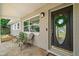 Inviting front porch with decorative door, stylish furniture, and lush plants at 2353 Eastwood Dr, Clearwater, FL 33765