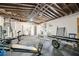 Spacious garage with exposed ceiling, containing fitness equipment, storage and laundry area at 2353 Eastwood Dr, Clearwater, FL 33765