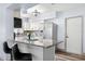Well-lit kitchen with breakfast bar, stainless steel appliances, and convenient access to the outdoors at 2353 Eastwood Dr, Clearwater, FL 33765