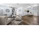 Open-concept living room with stylish decor, modern lighting, and wood-look flooring at 2353 Eastwood Dr, Clearwater, FL 33765