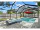 Screened-in pool and spa surrounded by brick pavers and a white privacy fence at 2353 Eastwood Dr, Clearwater, FL 33765