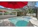 Relax in the screened-in pool and spa, adjacent to the house, perfect for entertaining at 2353 Eastwood Dr, Clearwater, FL 33765