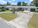Aerial view of a well-kept house with a green lawn, driveway, and landscaping at 2502 Tropical Shores Se Dr, St Petersburg, FL 33705