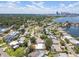 Picturesque aerial view featuring homes with pools, lush trees, and a stunning cityscape backdrop at 2502 Tropical Shores Se Dr, St Petersburg, FL 33705