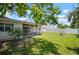 Serene backyard featuring mature trees, a screened-in patio, and a peaceful setting at 2502 Tropical Shores Se Dr, St Petersburg, FL 33705