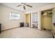 Bedroom with open closet, dresser, and ceiling fan at 2502 Tropical Shores Se Dr, St Petersburg, FL 33705
