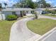 Charming single-story home featuring a curved driveway and a well-maintained front yard at 2502 Tropical Shores Se Dr, St Petersburg, FL 33705