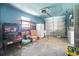 Spacious garage features a white refrigerator, shelving unit, and a two-car garage door at 2502 Tropical Shores Se Dr, St Petersburg, FL 33705