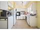 Functional kitchen with white cabinets, appliances, and ample counter space at 2502 Tropical Shores Se Dr, St Petersburg, FL 33705
